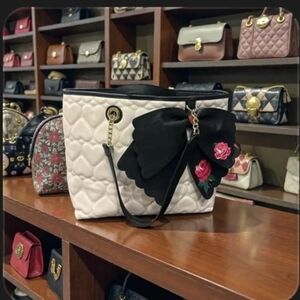 Elegant Black and White L Tote Bag with Floral Accent Betsy Johnson Collection